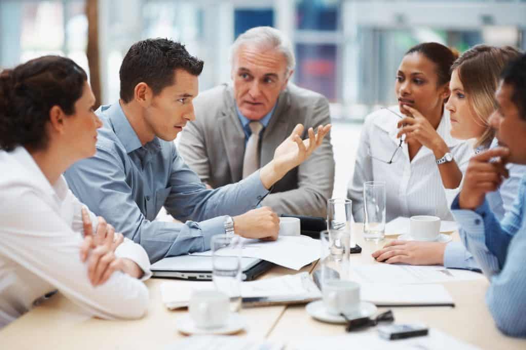 Young man presenting his ideas to his business team